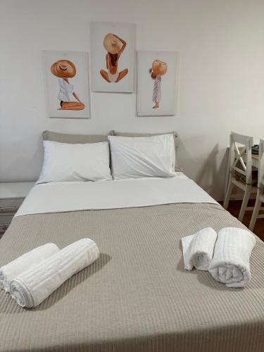 a bedroom with a bed with towels on it at Tinos dream sea ,150m from the beach in Agios Sostis