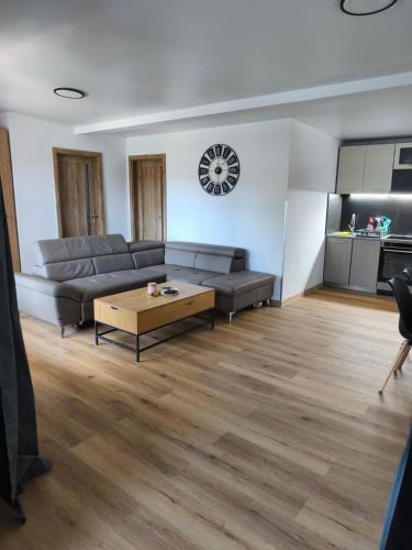 a living room with a couch and a coffee table at Chatka Katka in Klokočov