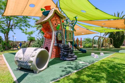 a playground in a park with a play structure at Royal Suite Caesarea in Caesarea