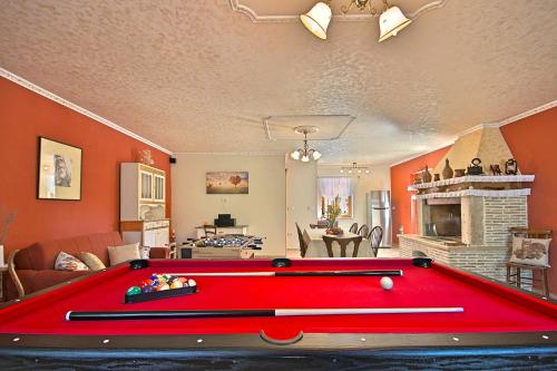 a red pool table in a living room with a fireplace at Villa Angela e Giovanni in Vižinada
