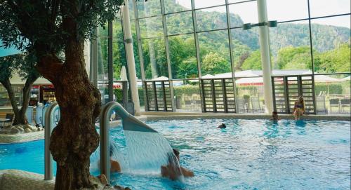 a swimming pool with a person going down a water slide at Pension Harzresidenz in Thale
