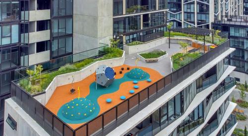 an aerial view of a building with a playground at 2B-1BR-1Car-Courtyard-CBD-Shops in Canberra