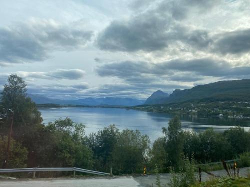 a view of a body of water with mountains at Lyngen Blue House in Lyngseidet