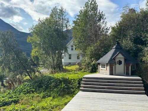 a small house sitting on top of a wooden deck at Lyngen Blue House in Lyngseidet