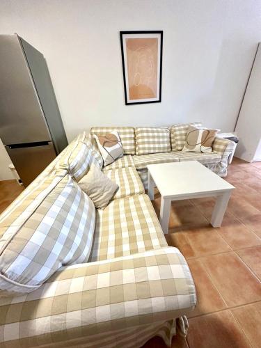 a living room with a couch and a table at Tinos dream sea ,150m from the beach in Agios Sostis