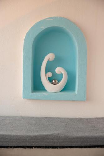 a blue object with a snake on a wall at Aurea Blu Studio 06, sun, beach, sea, relaxation in Aliko Beach