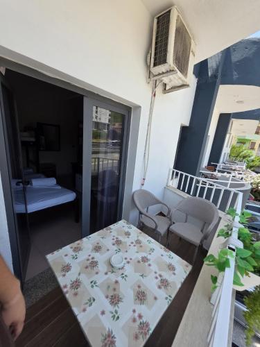 a small room with a table and chairs on a balcony at Seashell Beach Rooms in Durrës
