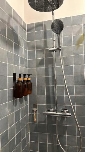 La salle de bains est pourvue d'une douche et de carrelage bleu. dans l'établissement Cocon Calanques Marseille, à Marseille