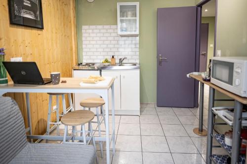 a kitchen with a table with a laptop on it at Fanta flat France Suisse in Saint-Louis