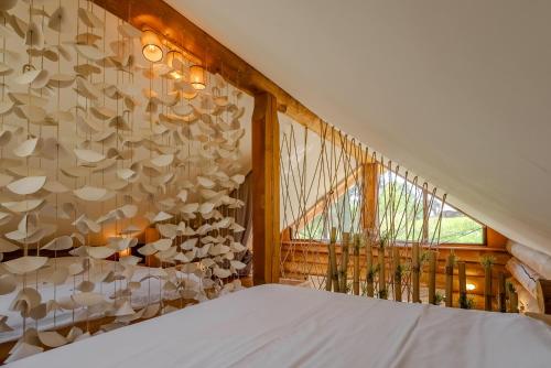 a bedroom with a wall covered in hats at Chalet -VV in Podčetrtek