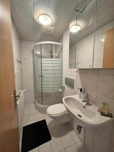 a bathroom with a toilet and a sink and a shower at Gasthof Barlida in Lainach