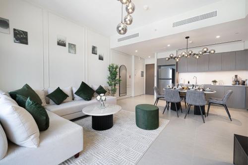 a living room with a couch and a table at SkyHigh 2BR Burj Views Steps to Dubai Mall in Dubai