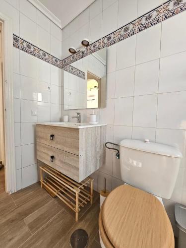 a bathroom with a toilet and a sink at Casa DaNa in Los Alcázares