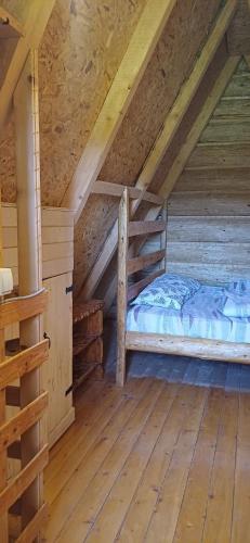 a bedroom with a bed in a attic at Etno SELO Uskoci in Uskoci