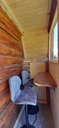 a room with two chairs and a table in a cabin at Etno SELO Uskoci in Uskoci