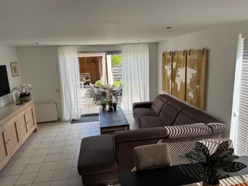 a living room with a couch and a table at Casa Bep in Zevenhuizen