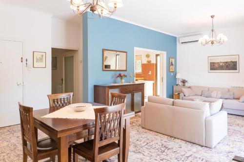 a living room with a table and chairs and a couch at Zina's Aqua Retreat - Kos in Ampavris
