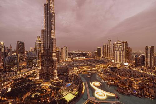 an aerial view of a city at night at SkyHigh 2BR Burj Views Steps to Dubai Mall in Dubai