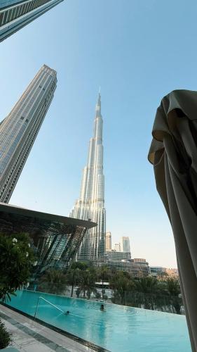 a view of a city from a building with a pool at SkyHigh 2BR Burj Views Steps to Dubai Mall in Dubai