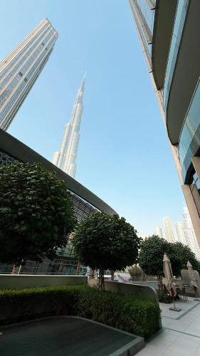 a view of a building with trees and buildings at SkyHigh 2BR Burj Views Steps to Dubai Mall in Dubai