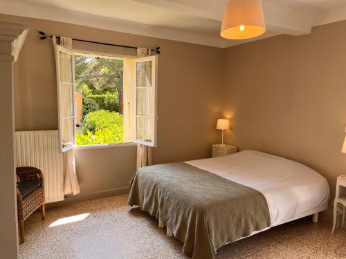 une chambre avec un lit et une fenêtre dans l'établissement La Fanette de Lure, à Pierrerue