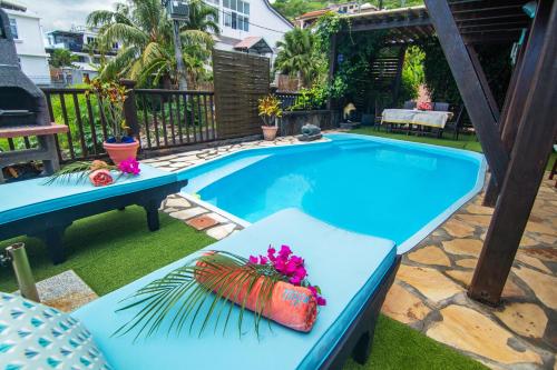 a pool with a lobster pillow and flowers on it at Blue Lagoon Villa in La Gaulette