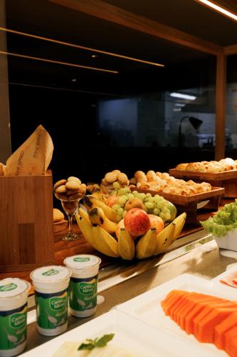 a bunch of bananas on a counter with other food at eSuites Savassi Toscanini in Belo Horizonte