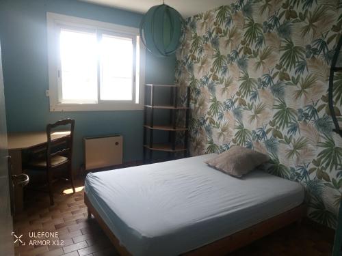 une petite chambre avec un lit et une fenêtre dans l'établissement Maison St Jean de Védas centre, à Saint-Jean-de-Védas