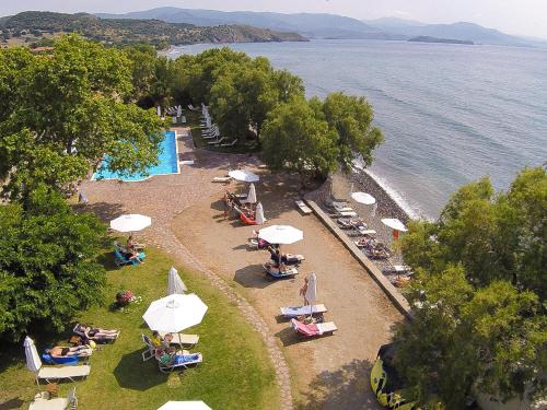 an overhead view of a beach with chairs and umbrellas at Olive Press Hotel in Mithymna
