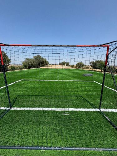 a soccer field with a net on a field at Torre Medieval de Queralt & Spa in Concabella