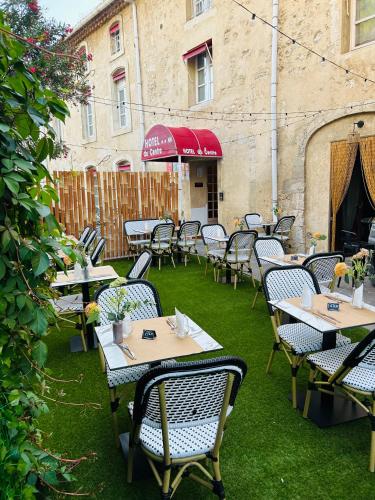 a group of tables and chairs on a patio at Hotel du Centre in Pierrelatte