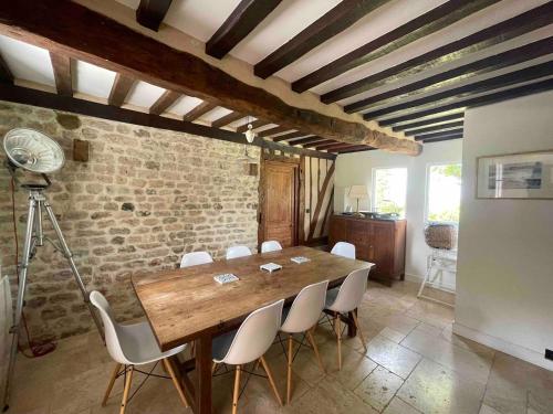 une salle à manger avec une table en bois et des chaises blanches dans l'établissement House in Villers-sur-Mer between Houlgate and Deauville, à Villers-sur-Mer