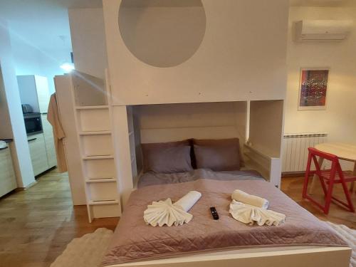 a bed in a room with a bunk bed at Pink Elephant in Subotica