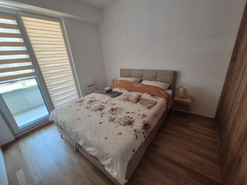 a bedroom with a large bed with flowers on it at Golden 25 Skopje in Skopje