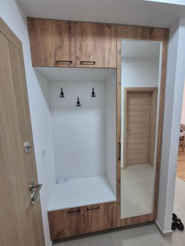 a dressing room with a mirror and a door at Golden 25 Skopje in Skopje