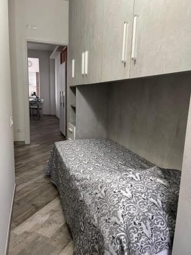a bedroom with a bed with a black and white blanket at BONBON in Rovigo