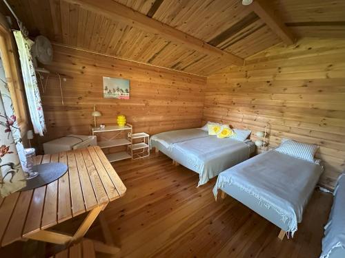a bedroom with two beds in a wooden room at Rendixime - Karjamaa Garden Bungalows Free parking and coffee in Pärnu