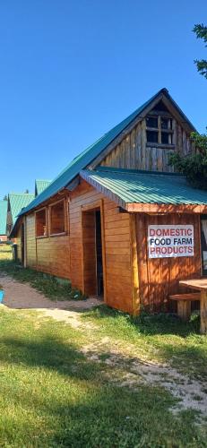 a wooden building with a sign on the side of it at Etno SELO Uskoci in Uskoci