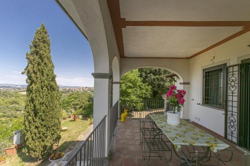a balcony with a table and chairs and a tree at Villa Bagolini in Mentana