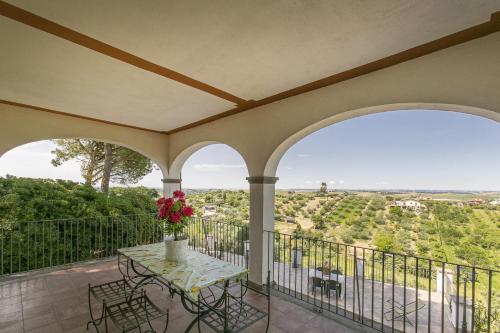 a balcony with a table with flowers on it at Villa Bagolini in Mentana
