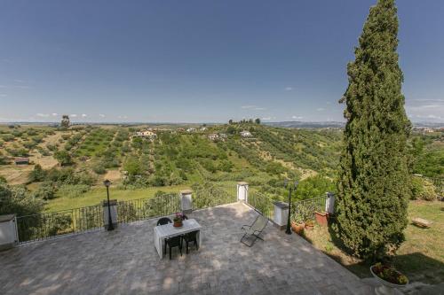 a patio with a table and a tree at Villa Bagolini in Mentana