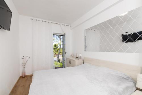 Ένα ή περισσότερα κρεβάτια σε δωμάτιο στο Apartments Dobronic
