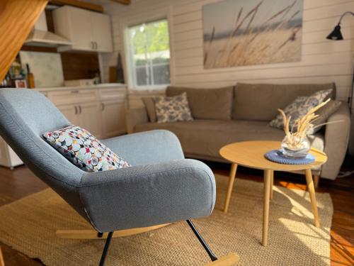 a living room with a couch and a table at Vila Preiloja in Neringa