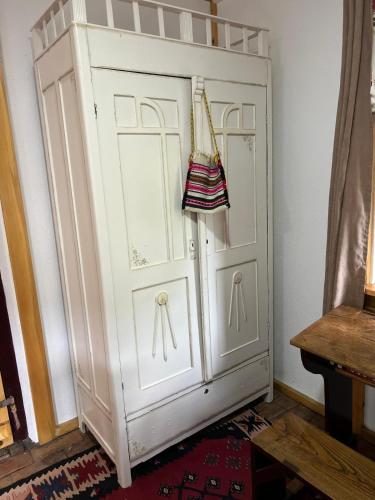 a large white door with a purse hanging on it at Etno kuća Danica in Senje