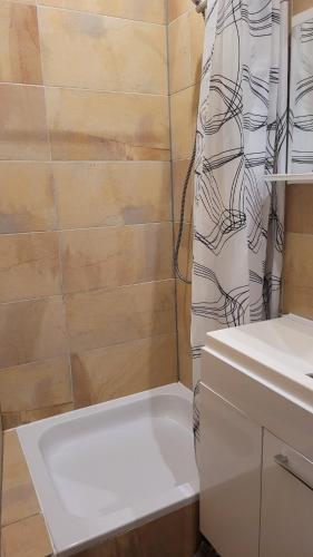 a bathroom with a tub and a sink and a shower at Privilege - Viel inklusiv! in Viersen