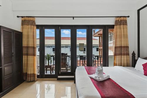 Postel nebo postele na pokoji v ubytování Central hotel Vang Vieng