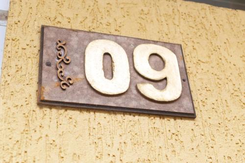 a sign on the side of a building with the number at Hotel Naturalis in Paranaguá