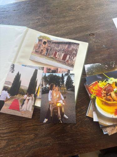 a table topped with photos of people on a table at Terracqua & Locanda Granducato in Chiusi
