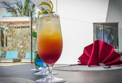 a drink in a glass sitting on a table at Loloata Island Resort in Loloata Island