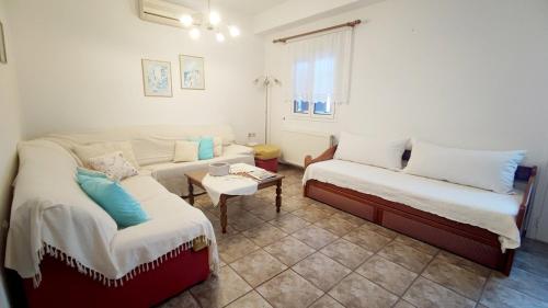 a living room with two beds and a couch at Kalliopi's Aegean View in Episkopíon